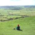 A lady meditating at Glastonbury Tor, England