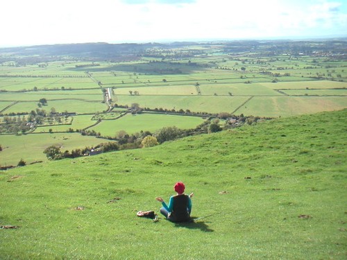 A lady meditating at Glastonbury Tor, England